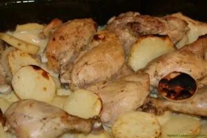 Mix garlic sauce with baked chicken and potatoes then broil for a few more minutes