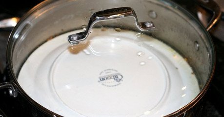 Top with ceramic plate and cook gently